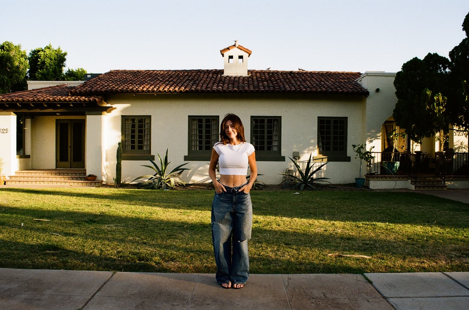 Lauren Curry standing in front of a Spanish Colonial home in Scottsdale, AZ
